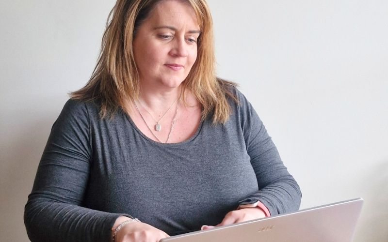 Ruth Slade from She Rocks Digital smiling warmly in a workspace, demonstrating the value of personal branding for Hobart digital marketing success